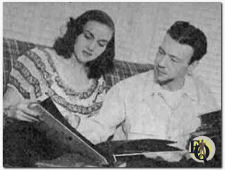 Howard Culver (R) and his wife Mimi (L) going over some photographs (1947)