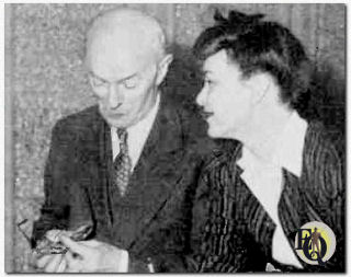 Arthur Allen (Doc Prouty) polishes his glasses to better see Marion Shockley (Nikki Porter).
