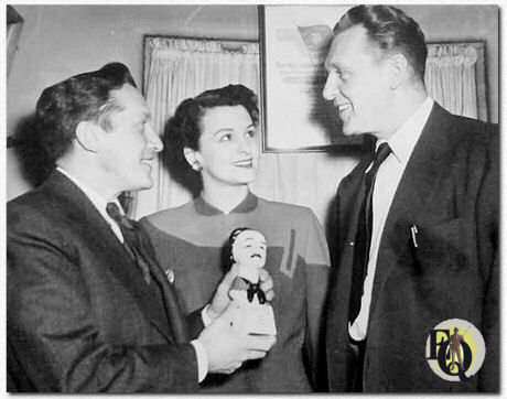 Sidney Kingsley, author of "Detective Story" showing Lydia Clarke and Ralph Bellamy, leading actors in his play, the 'Edgar' which he received from the Mystery Writers of America for his authentic portrayal of detectives in his hit play at the Hudson Theater, NY.