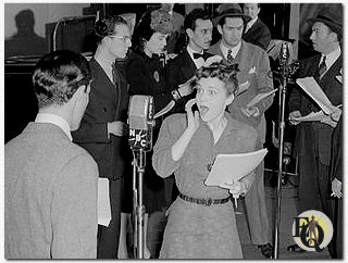 The cast for "The Adventures of Ellery Queen", Carleton Young and Marion Shockley before the NBC microphone (1942).