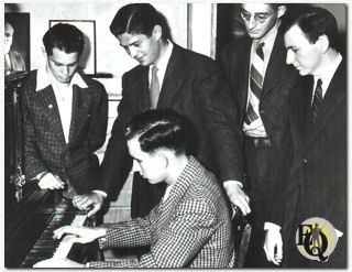 George Nader (standing behind piano player) was 20 when this candid photo was snapped at the Phi Gamma Delta Fraternity house in Occidental College.