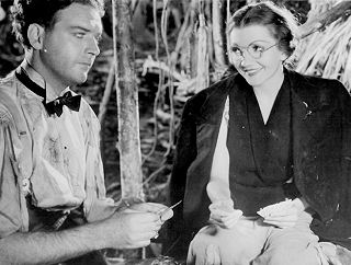 Stewart Corder (William Gargan) with schoolteacher Judy Jones (Claudette Colbert) in "Four Frightened People" (1934).