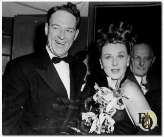 Paulette Goddard auctions off her orchid corsage with William Gargan calling the bids at the War Bond Rally in Madison Square Garden (September 30. 1942).