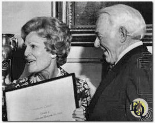 Washington, April 18. 1974 - A Kiss and an Award. Veteran actor William Gargan, who lost his larynx to cancer, gets a kiss from First Lady Pat Nixon along with the American Cancer Society's annual "courage award". Thursday at the White House. Gargan said he felt very humble adding "For the first time in my life I can't think of a funny joke."
