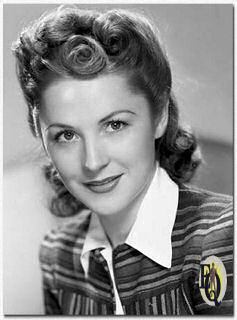 Helen Lewis models hair styles for a portrait in New York City. She has a role in the soap opera "Kate Hopkins, Angel of Mercy" (April 7, 1941)