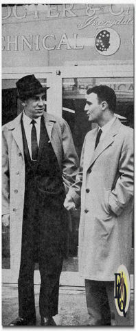 Rex Marshall (L), tv voice for Procter & Gamble's Gleem toothpaste, was part of Compton Adv.'s team that made a yearend report to the client in Cincinnati. Mr. Marshall also toured company facilities, including a visit to P&G's Technical Center, accompanied by an unidentified company representative. The announcer learned how new products are developed and tested. ("Broadcasting Telecasting", Jan - Mar 1961)
