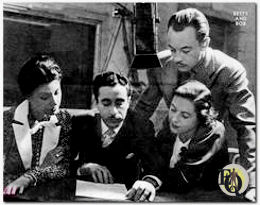 (L-R) Elizabeth Reller, Les Weinrott, Dorothy Shideler and Les Tremayne (standing) before the "Betty and Bob" microphone.