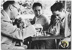Fred plays chess with son Doug, 22 (now also trying his hand at writing) while wife Hilda ("Bill") kibitzes. Other son, Richard is, at 16, a talented magician. (Photo with original caption from Coronet magazine, 1956).