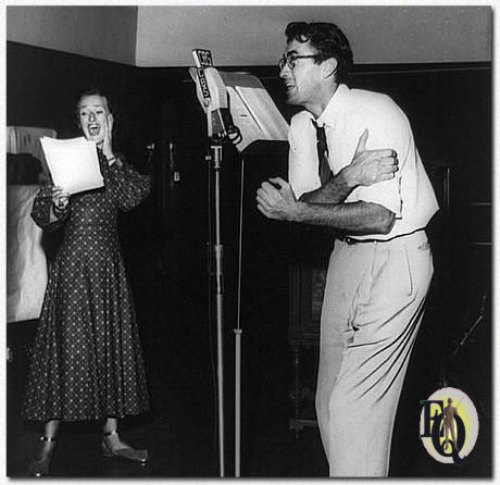 Gregory Peck at microphone with Kaye Brinker in radio's "Hitch-Hike Poker" (1948).