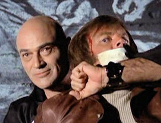 Dobkin as mass murderer Gregory Praxas in a 1972 pilot film for "Streets of San Francisco" holds David J. Farr (Robert Wagner).