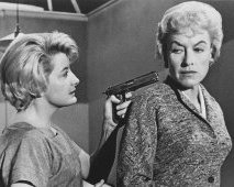 Constance Ford is holding the gun to Virginia's head in "House of Women" (1962)