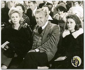 DEADLY ART AUCTION -- Lillian McGraw (Dr. Joyce Brother, left), her husband, Clint (Forrest Tucker), and her cousin, Celeste (Vera Miles), attend an art auction where Lillian buys the portrait of a woman and soon after is slain in "The Two-Faced Woman" on NBC-TV's "Ellery Queen" color-cast, Feb.29 (8-9 P.M. NYT).