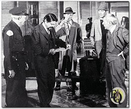 Taped outline of where the body fell provides grim meeting place for principals in the "Ellery Queen" colorcast of "The Pharoah's Curse" The men are (from left) Wallace Rooney as museum guard, Ross Martin as museum director, Tom Reese as police sergeant Velie, Jim Hutton as Ellery Queen and David Wayne as Inspector Queen.